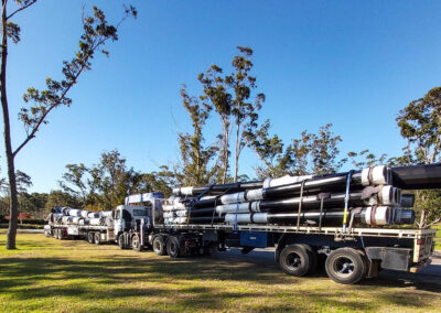 GM Poles flatbed trucks packed high with sections of black powdercoated poles ready to be fitted together on site at Willinga Park show jumping arena